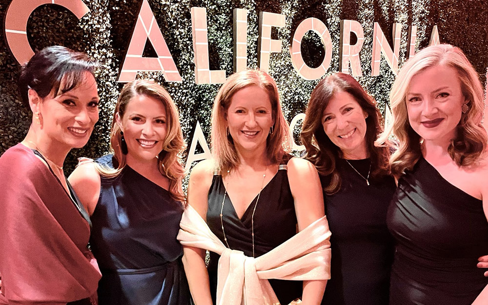 Five women standing in front of a sign that says California