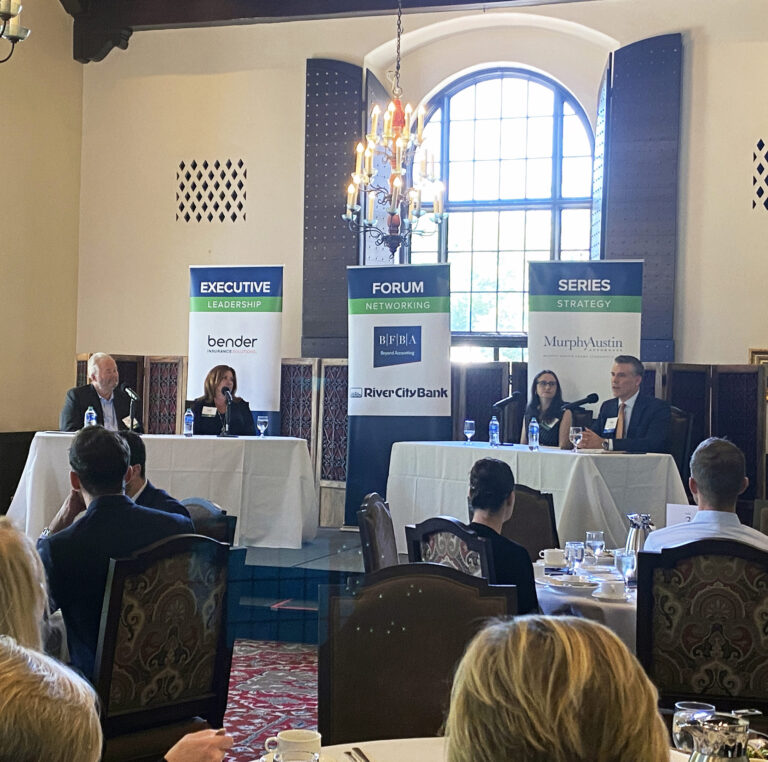 Photo of two men and two women sitting at tables.
